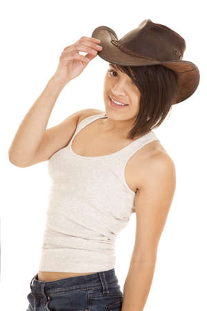 A woman with a smile on her face in her tank and her cowgirl hat.の写真素材