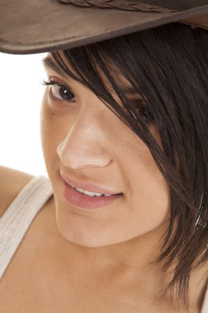 A woman with a smile on her lips wearing her hatの写真素材