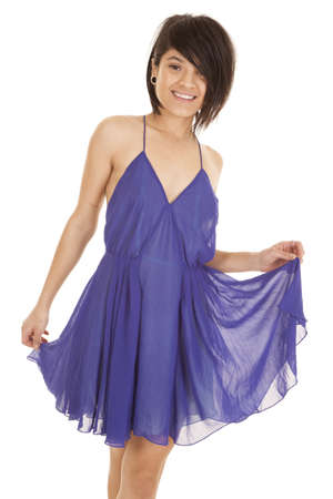 a woman with a smile on her face holding out her sheer dress.の写真素材