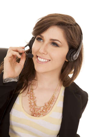 a business woman with her headset on with a smile on her faceの写真素材