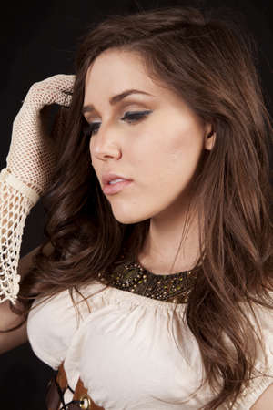 a close up of a woman's face in her western vintage dress and gloves.の写真素材