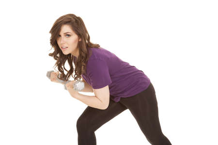 A woman working out with weights, working out her arms.の写真素材