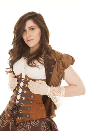 a woman in her vintage western clothing with her hands on her chest with a small smile.の写真素材