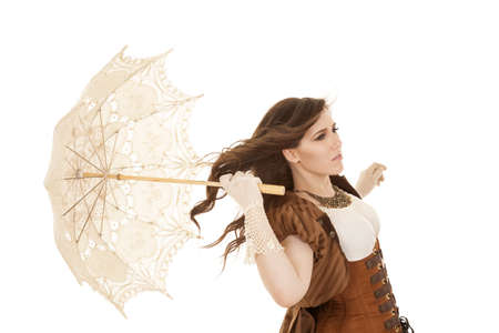 A woman holding her umbrella with the wind blowing in her face.の写真素材
