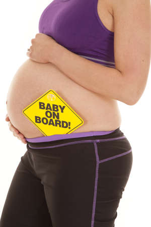 A close up of a woman's belly with a sign on itの写真素材