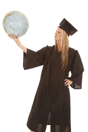 A graduate female holding on to the world in her hand.の写真素材