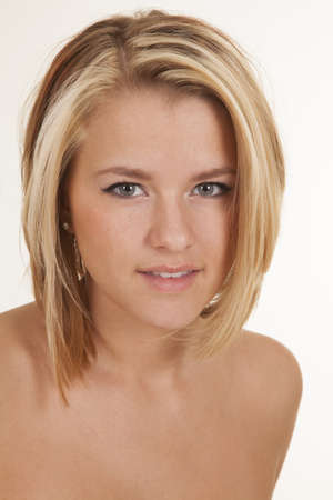 a woman with a smile on her face with her shoulders bareの写真素材