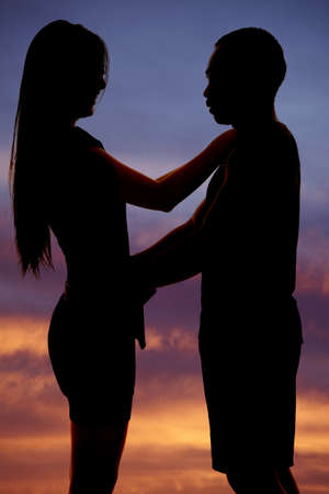 A silhouette of a man and woman in each others armsの写真素材