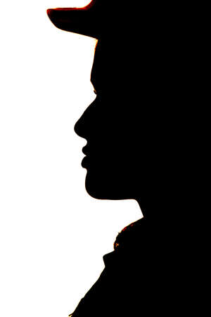 A close up silhouette of a face with a hard hat onの写真素材