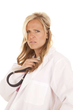 a woman doctor listening to her own heart not sure what to thinkの写真素材