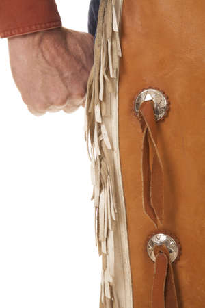 A close up of a cowboys fist and chapsの写真素材