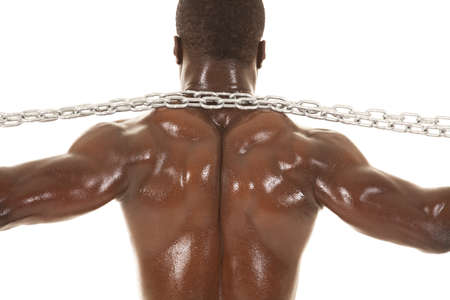 An African American man shirtless holding a chain from the back.