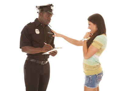 a woman flirting with a policeman to get out of a ticket.の写真素材