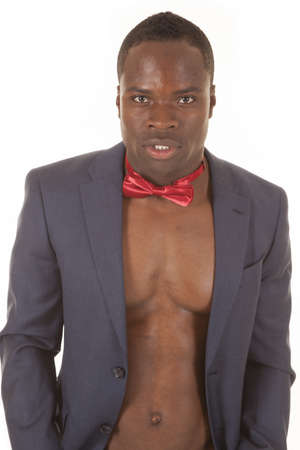 A man without a shirt in a suit coat and a bow tie.の写真素材