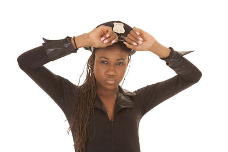A woman cop up close holding her hat.の写真素材