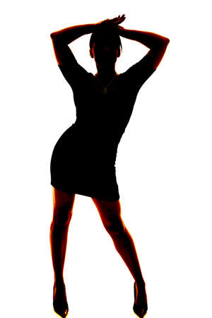 A silhouette of a woman dancing in her skirt and heels.の写真素材