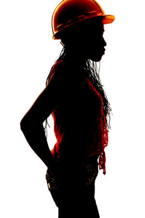 a silhouette of a woman in her construction helmet.の写真素材