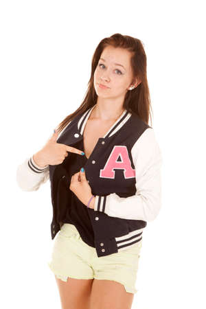 A girl is pointing to the letter on her jacket.の写真素材