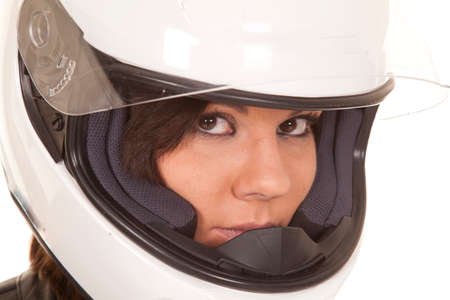 A close up of a woman biker in her helmet with a serious expression on her face.の写真素材