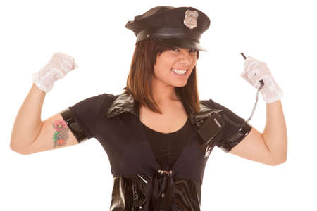 A woman police officer flexing her arms with a big grin on her face.