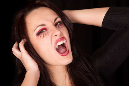 A woman vampire showing off her teeth with her mouth open.の写真素材