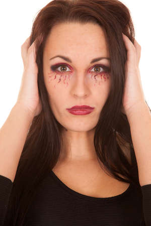 A woman vampire showing off her teeth with her hands in her hair.の写真素材