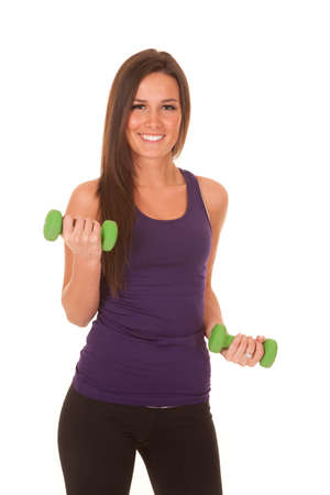 A woman in a purple tank is curling weights.の写真素材