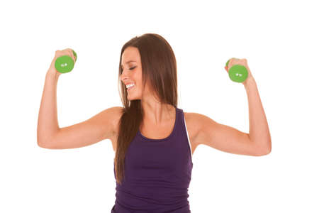A woman is in a purple tank top flexing looking to the side.の写真素材