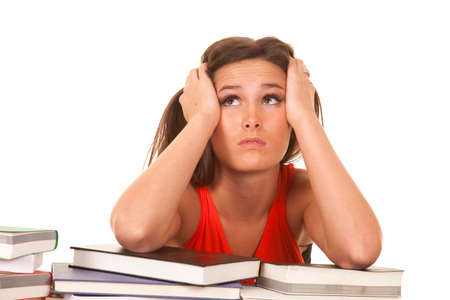 A woman is frustrated while studying her books.の写真素材