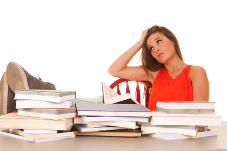 A woman with lots of books is stressed.の写真素材