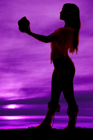 A silhouette of a Native American woman holding a pot.の写真素材