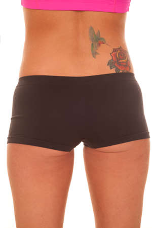 A woman has a tattoo on her lower back.の写真素材