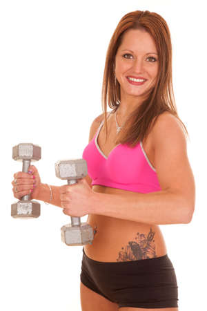 A woman is curling weights and is smiling.の写真素材