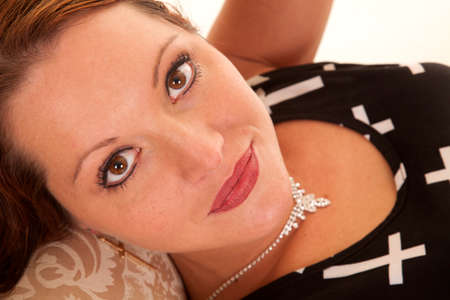 A close up of a woman laying on a fancy bench.の写真素材