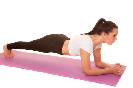 A woman working out her body by doing plank.