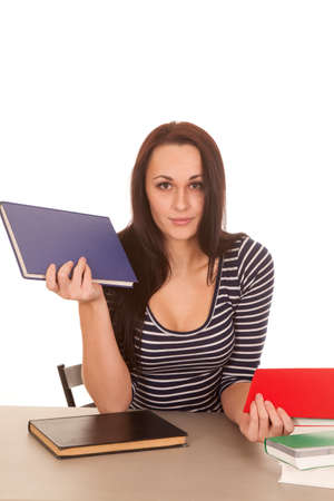 A woman with books in her hands with a serious expressions on her face.の写真素材