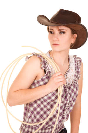 a cowgirl holding on to her rope wearing her hat.の写真素材