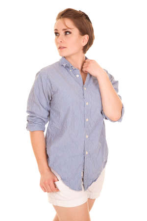 a woman in her striped shirt and shorts looking to the side.の写真素材