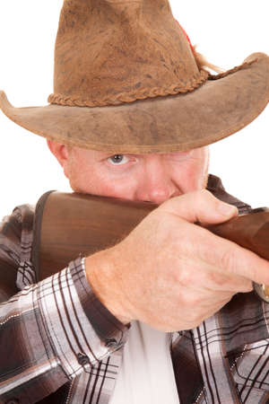 a close up of a cowboy holding on to his gun.