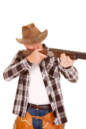 a cowboy holding on to his gun, taking aim.の写真素材