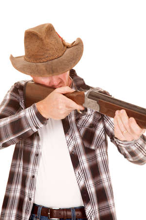 a cowboy holding on to his gun, taking aim.の写真素材