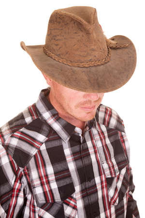 A close up of a cowboy with his face hidden .の写真素材