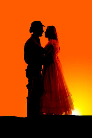 a silhouette of couple in their western clothes.の写真素材
