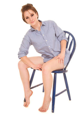 a woman sitting in a chair with a smile on her face.の写真素材