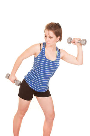 A woman working out with weights building up her muscles.の写真素材