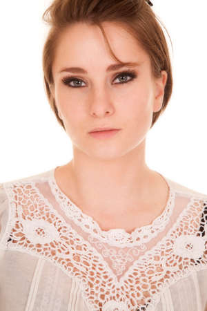 a woman in a lace top with a serious expression on her face.の写真素材