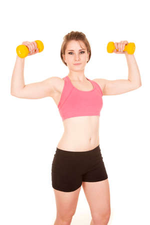 a woman working out with her weights with a small smile.の写真素材
