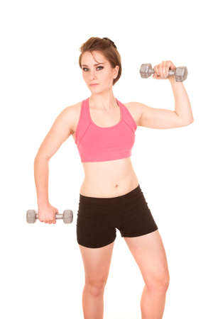 a woman working out with weights with a serious expression.の写真素材