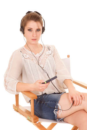 a woman with a serious expression on her face listening to musicの写真素材