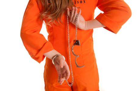A woman from the back taking off handcuffs.の写真素材